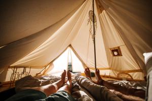 a group of people laying on a bed in a tent at Lago Valle Wine Glamping in Valle de Guadalupe
