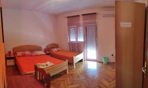 a small room with two beds and a window at Rooms Raulo in Split