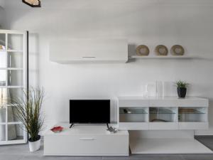 a living room with a tv on a white cabinet at Apartment Pueblo Quinta-3 by Interhome in Benalmádena