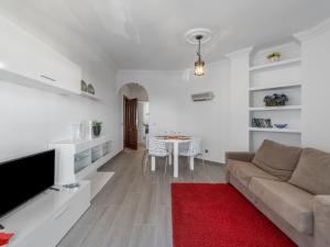 a living room with a couch and a red rug at Apartment Pueblo Quinta-3 by Interhome in Benalmádena
