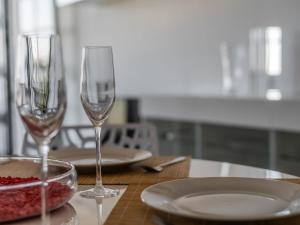 two wine glasses sitting on a table with a plate at Apartment Pueblo Quinta-3 by Interhome in Benalmádena +19 photos