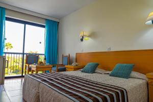 Postel nebo postele na pokoji v ubytování Veronica Hotel