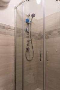 a shower with a glass door in a bathroom at Affittacamere Al Corso in San Martino dʼAgri