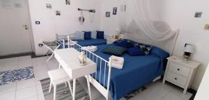 a bedroom with a blue bed and a staircase at Torreammare in Salerno