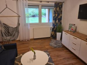 a living room with a couch and a table and a window at Apartament pod wieżą Sky Walk in Świeradów-Zdrój