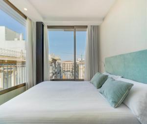 a bedroom with a large bed with a large window at San Sebastian Suites in Cartagena +84 photos