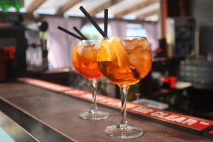 two cocktails sitting on top of a bar at Second Floor Apartament in Liepāja