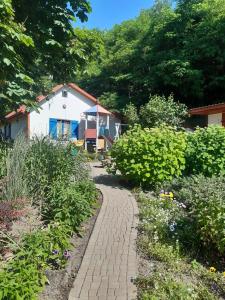 a brick path in a garden with a house at Domek na Podlasiu in Mielnik