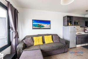 a living room with a couch and a kitchen at Vivienda Vacacional Lizzy in Puerto del Carmen