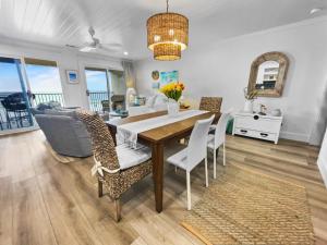 a dining room and living room with a table and chairs at Endless Waves -208 ES Condo in Santa Rosa Beach
