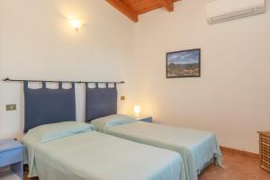Villa Diomede tesisinde bir odada yatak veya yataklar