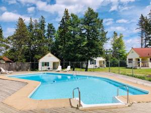 una piscina en un patio con una casa en Green Gables Bungalow Court en Cavendish