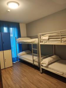 a room with three bunk beds in it at Pensión San Fermín in San Sebastián