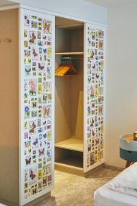 a closet with a door with lots of stickers at Landgasthof Seemer in Wenholthausen