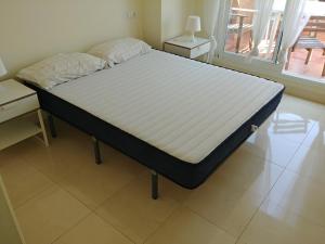 łóżko w pokoju z białym materacem w obiekcie Mojacar Playa para Familias w mieście Mojácar +23 zdjęcia