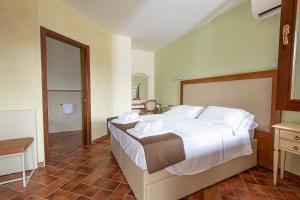 Postel nebo postele na pokoji v ubytování Resort Capalbio