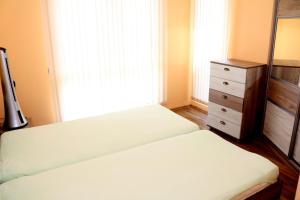 Un pat sau paturi într-o cameră la Saint John Resort E301