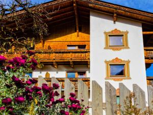 a house with a fence and flowers at Apartment Anna by Interhome in Neustift im Stubaital