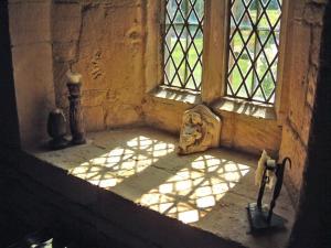 a window with sunlight shining into a room at Abbots Grange Manor House in Broadway