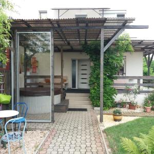 a house with a glass door and a patio at Aliz Apartman in Nyíregyháza +17 photos