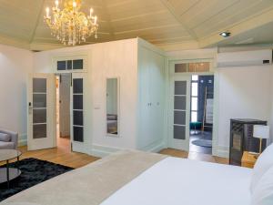 a bedroom with a bed and a chandelier at Douro Village in Vila Real