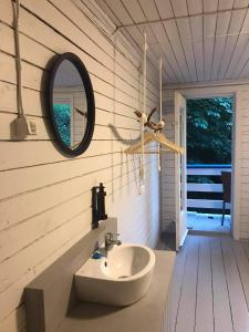 a bathroom with a sink and a mirror on the wall at Poilsio namai Žuvėdra in Nida