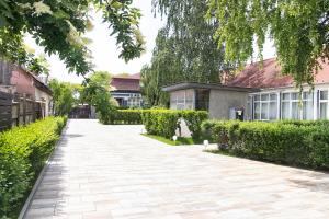 a brick walkway in front of a house at Airport Wanderer Inn - Vándor fogadó in Vecsés