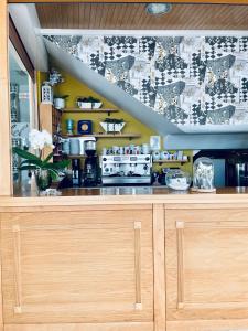 a kitchen with a counter with a stove top oven at Hostal Casa Isabel in Portonovo