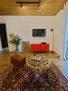 a living room with a coffee table and a tv at ZakoRustic in Zakopane