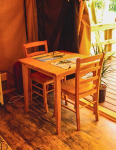 a wooden table with two chairs and a table and a table and chairs at Country Road Cabins in Hico