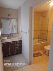 a bathroom with a sink and a shower and a toilet at Giova Apart Salta in Salta