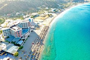 an aerial view of a beach with hotels and the ocean at Konstantinos Palace in Karpathos +37 photos