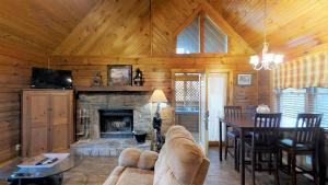 a living room with a couch and a fireplace at Cozy Cottage Unit 1610 Cabin in Waldens Creek +13 photos