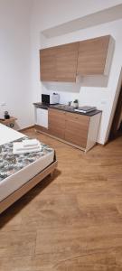 a room with a kitchen and a bed in it at Christian Guest House in Terrasini