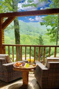 a table on a porch with two glasses of wine at Big Kahuna Lodge cabin in Sevierville