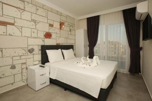 Ένα ή περισσότερα κρεβάτια σε δωμάτιο στο Lebedos Apart Hotel
