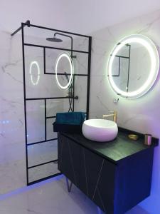 a bathroom with a sink and a mirror on a counter at Suite Miro Charme et volupté in Perpignan +10 photos
