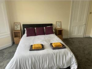 a bedroom with a bed with two towels on it at Grangemouth Apartments in Falkirk