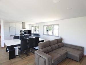 a kitchen and living room with a couch and a table at Moradia Faria in Fataca