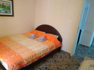 ウトイェハにあるMonoLizaのベッドルーム1室(オレンジ色の掛け布団付きのベッド1台付)
