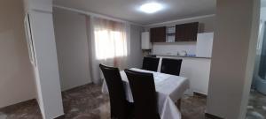 a kitchen with a table and chairs in a room at Casă de vacanță in Izvoare