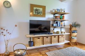 a living room with a flat screen tv on a stand at Residence Nespula in Punat