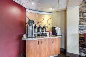 a coffee station in a restaurant with a red wall at Red Roof Inn Minneapolis Plymouth in Plymouth