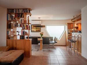 a living room with a dining room table and chairs at Moai Home Apartman Sárvár in Sárvár