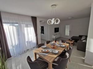 a dining room table and chairs in a living room at Apartments Ivana in Sveti Filip i Jakov