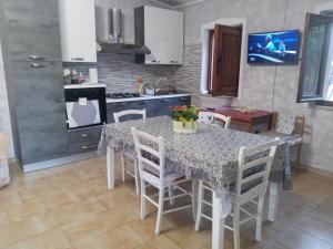 a kitchen with a table and chairs in a kitchen at Dolce casa in Gonnesa