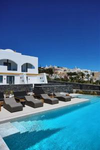 a pool with chaise lounge chairs next to a building at Alleys All-Suite Hotel & Spa in Pirgos
