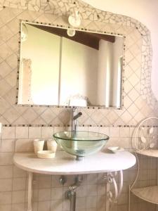 a bathroom with a glass sink and a mirror at Appartamento VILLA ADRY in Rome