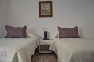 two beds sitting next to each other in a room at CASA CARAVINA in Benimantell