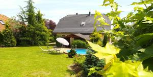 a house with a swimming pool in a yard at Vila Callum RELAX & WELLNESS in Ostrava